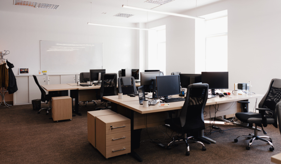 IT open space office. Computer Work Stations. Office Workplace with windows.